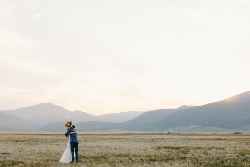 bride and groom during sunset portraits in colorado with vista views in the background