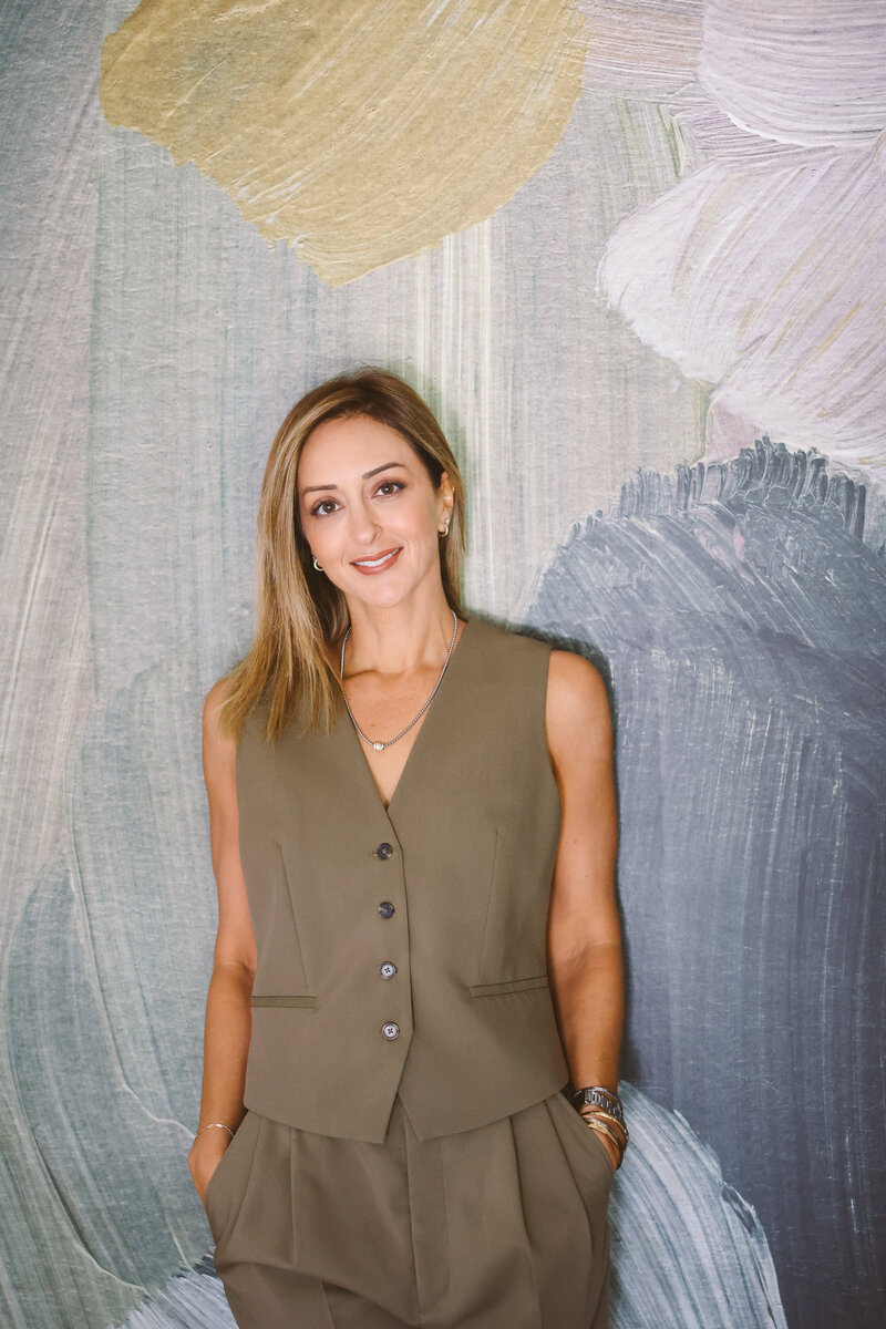 Cindy Barbara sitting in a chair at home.