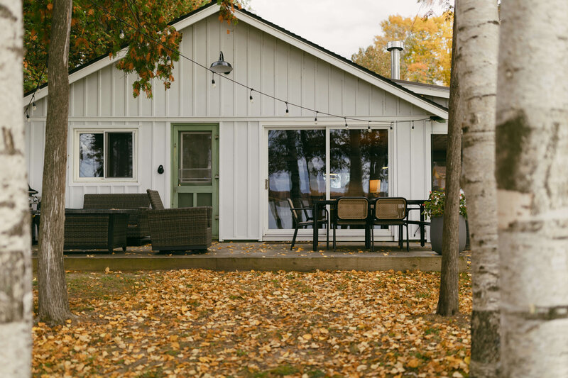 White cottage in the woods during falltime