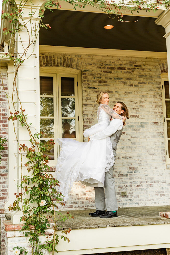 Groom kissing his bride as guests blow bubbles