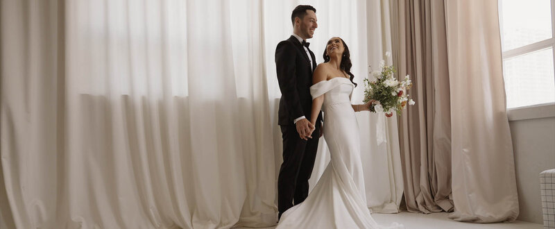 Bride smiling up at groom