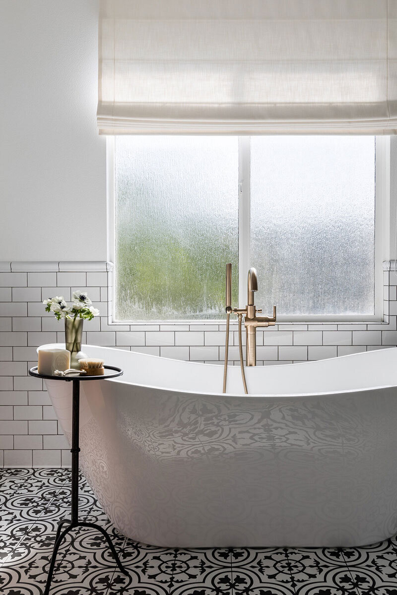 Bathroom with marble accents and soft, cozy coastal elements in this Costa Mesa home
