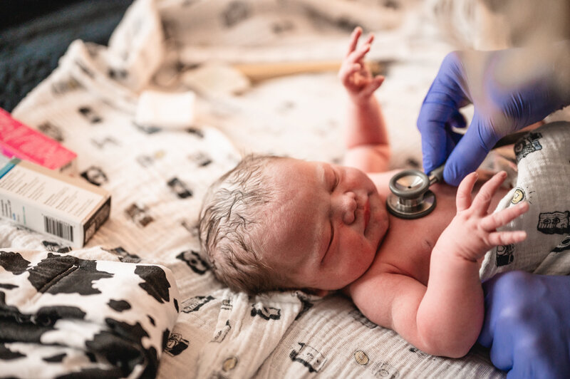 Newborn baby lying on hospital blanket during birth session — lifestyle newborn photography in Dallas–Fort Worth by Poppy + Blue Photography