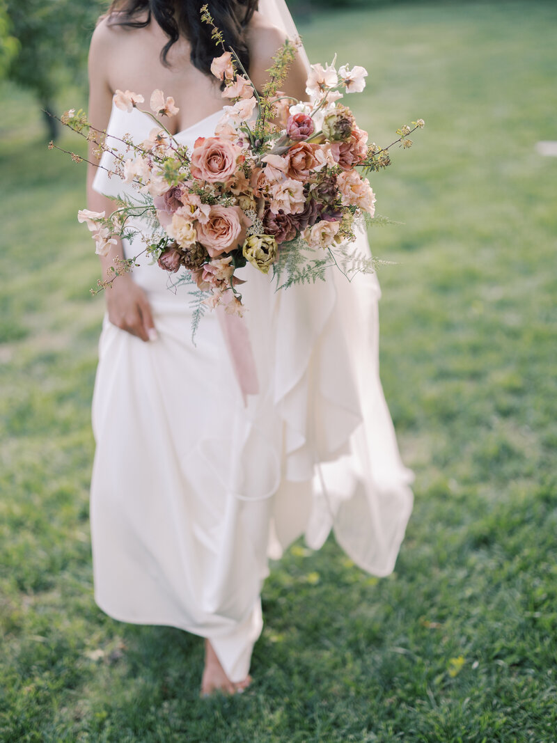A close up of a joyful bride and groom right before they kiss