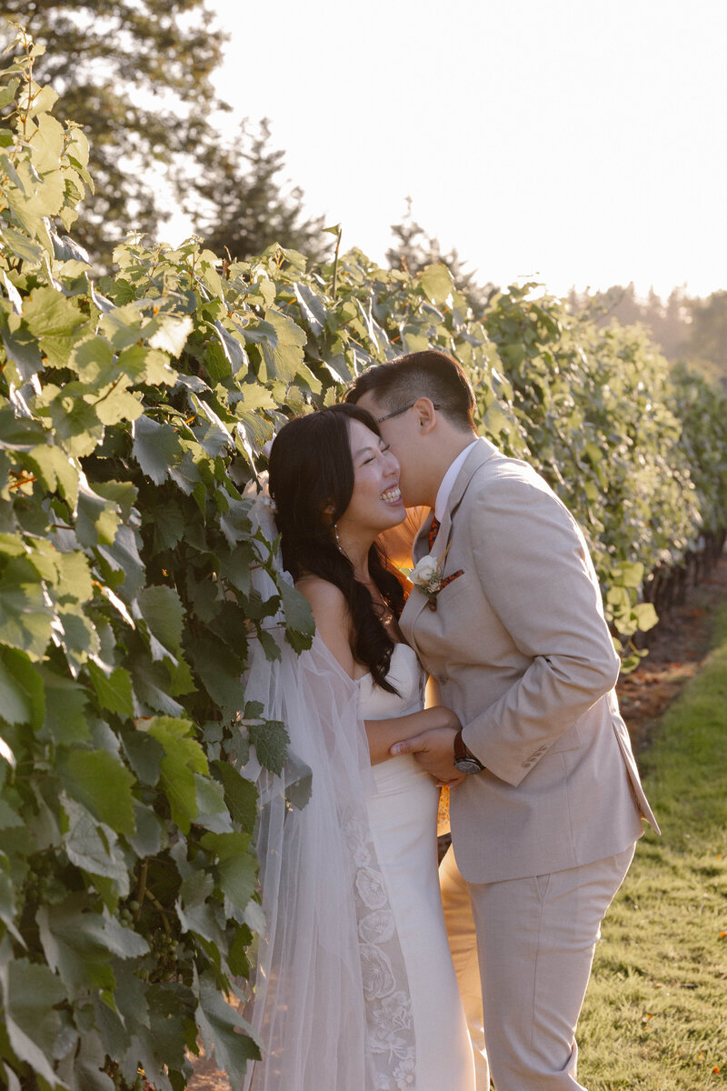 bride and groom kissing with confetti