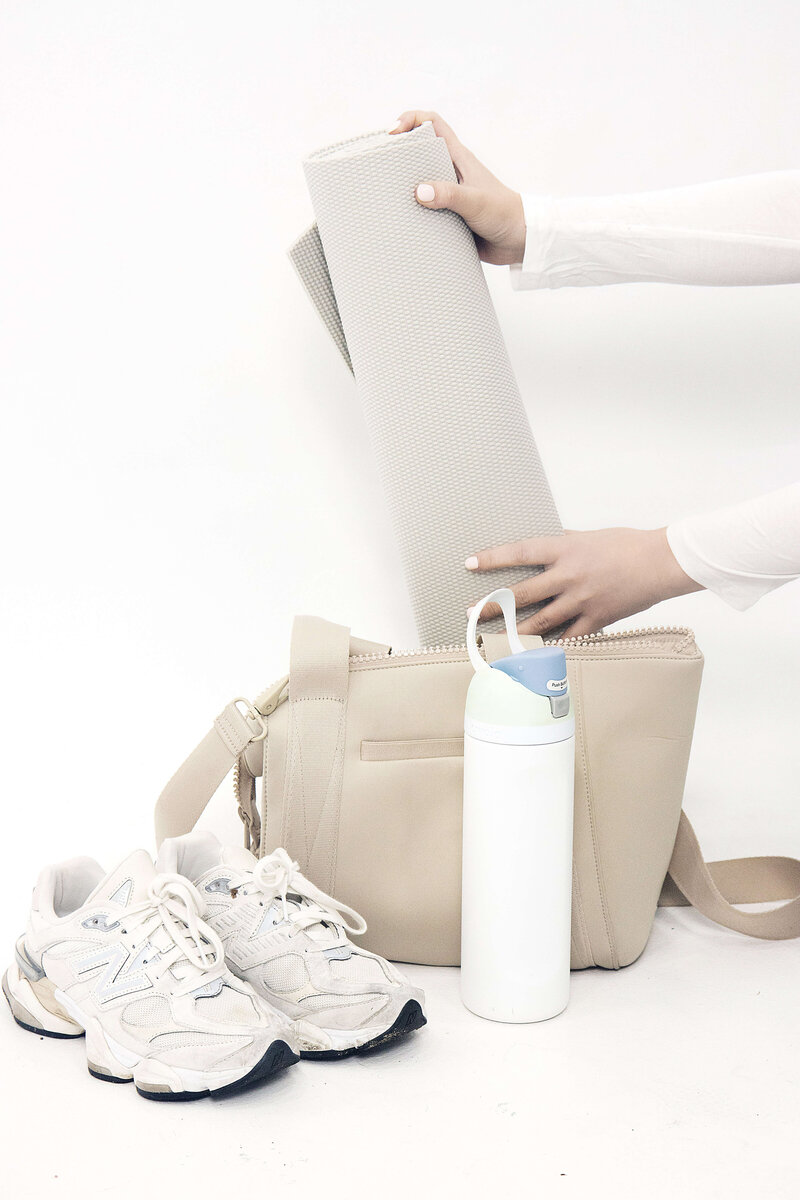 Essentials to bring for your first Lagree class at Rise Studio in Poway—grip socks, water bottle, and gym bag