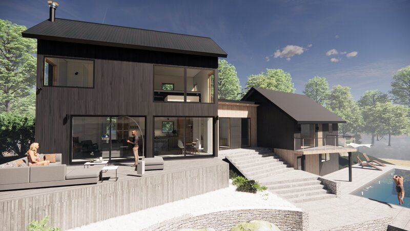 A modern two-story house by Catskill Architects features large windows, wood siding, and a spacious patio. A person stands outside, with stairs leading to a lower level framed by landscaped stone walls and lush greenery.