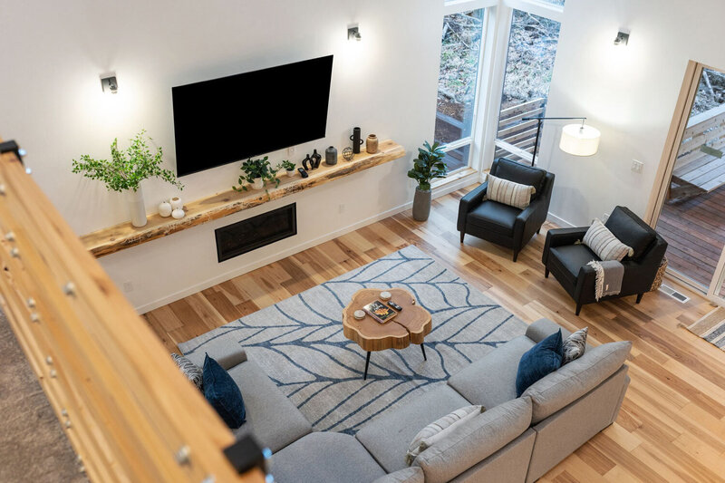 Cozy modern living room with large windows and warm decor