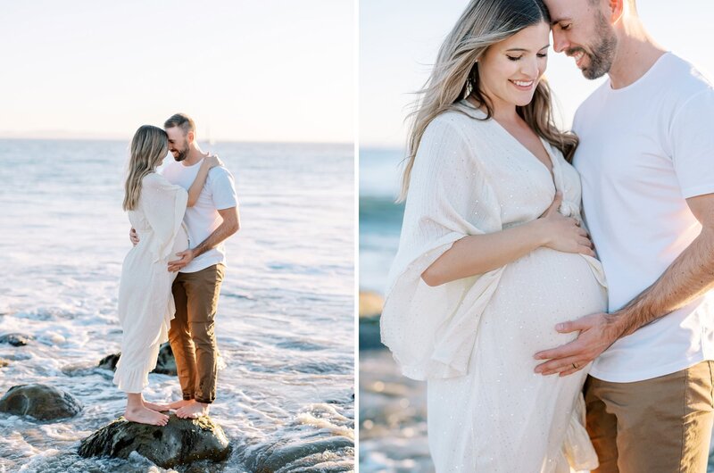 A couple kissing while standing on rocks in the surf during their Santa Barbara maternity session