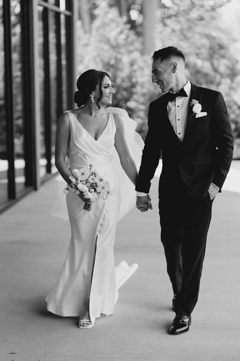couple walking in a black and white photo