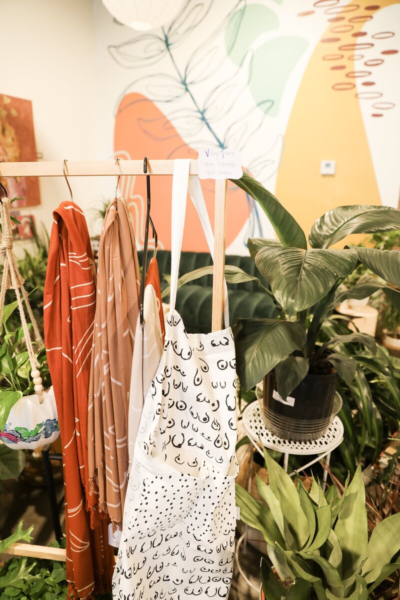 Abstract scarfs and bags hanging in a plant shop