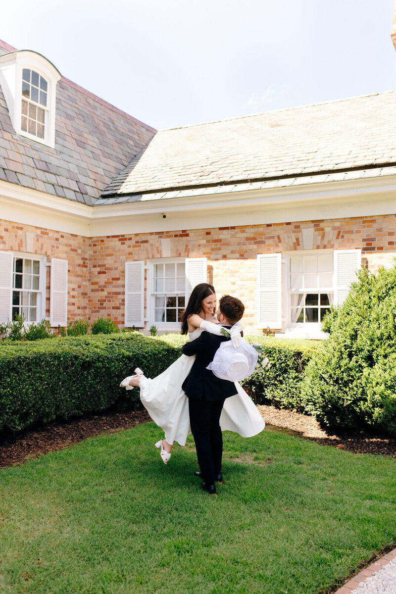 A bride and groom kissing in a large field.