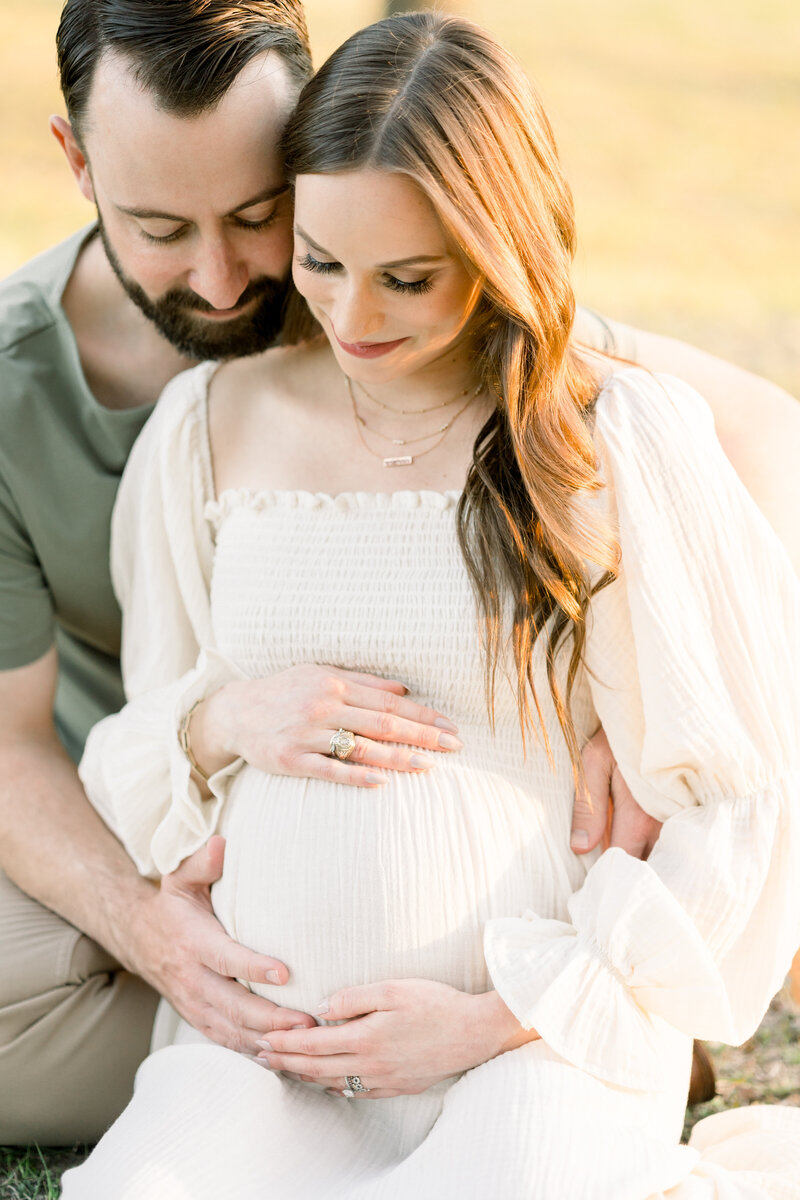 a man embracing his pregnant wife