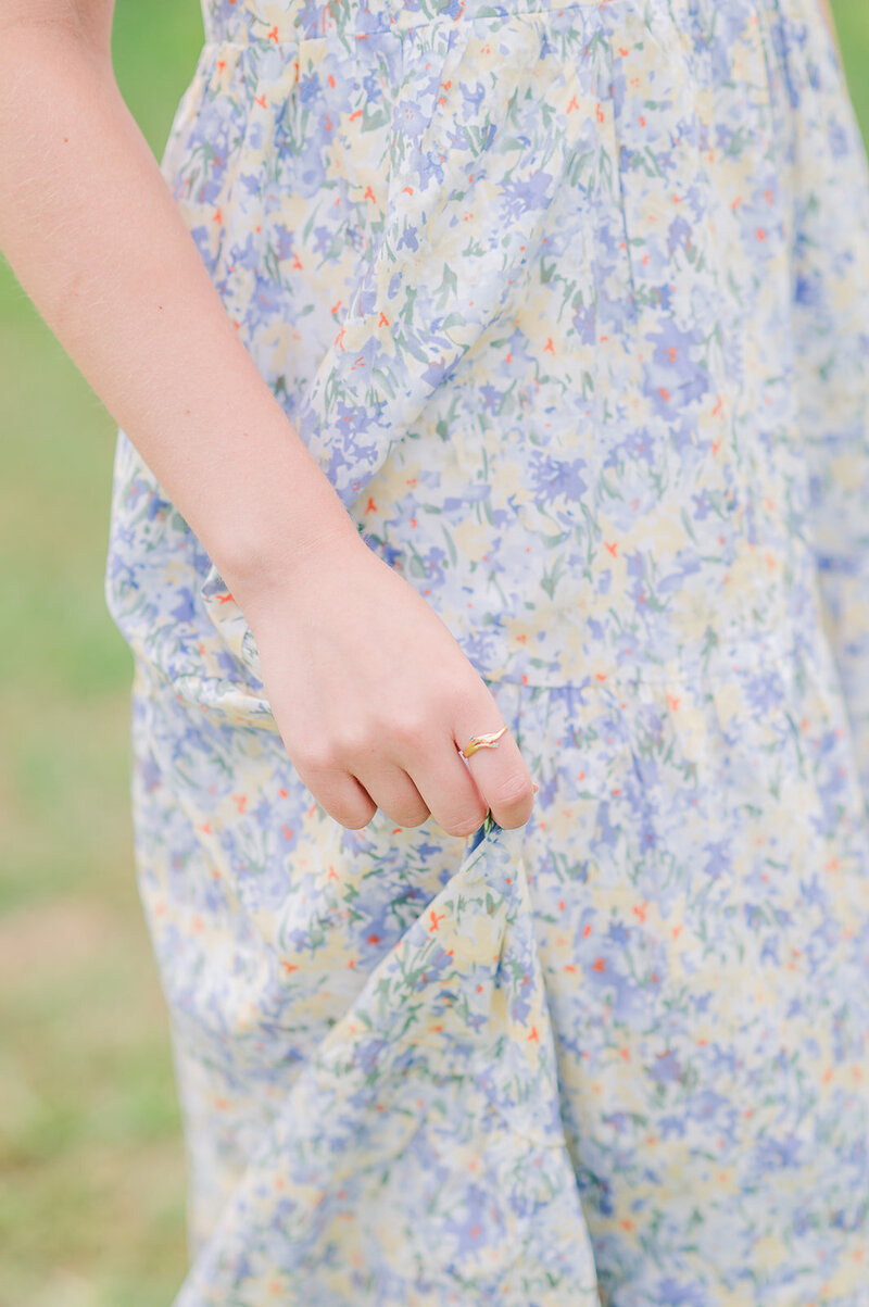 close up of a girl in a blue floral dress