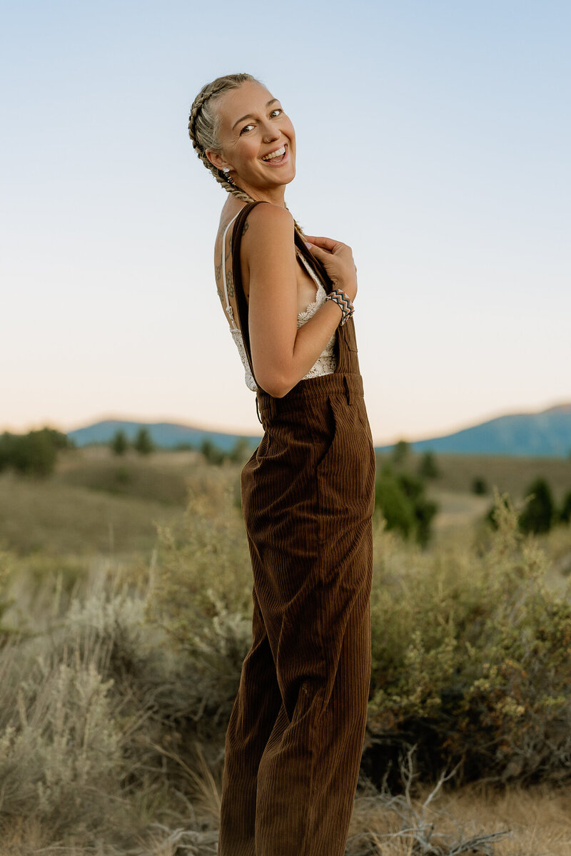 Christina Landini looking at the camera with a hat and white dress.