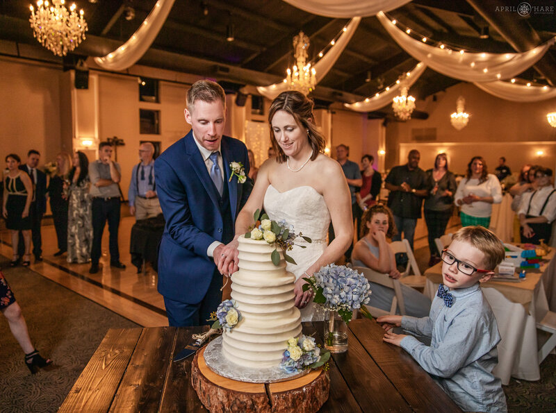 Cutting the cake at a Black Forest Wedgewood Weddings Reception in Colorado Springs