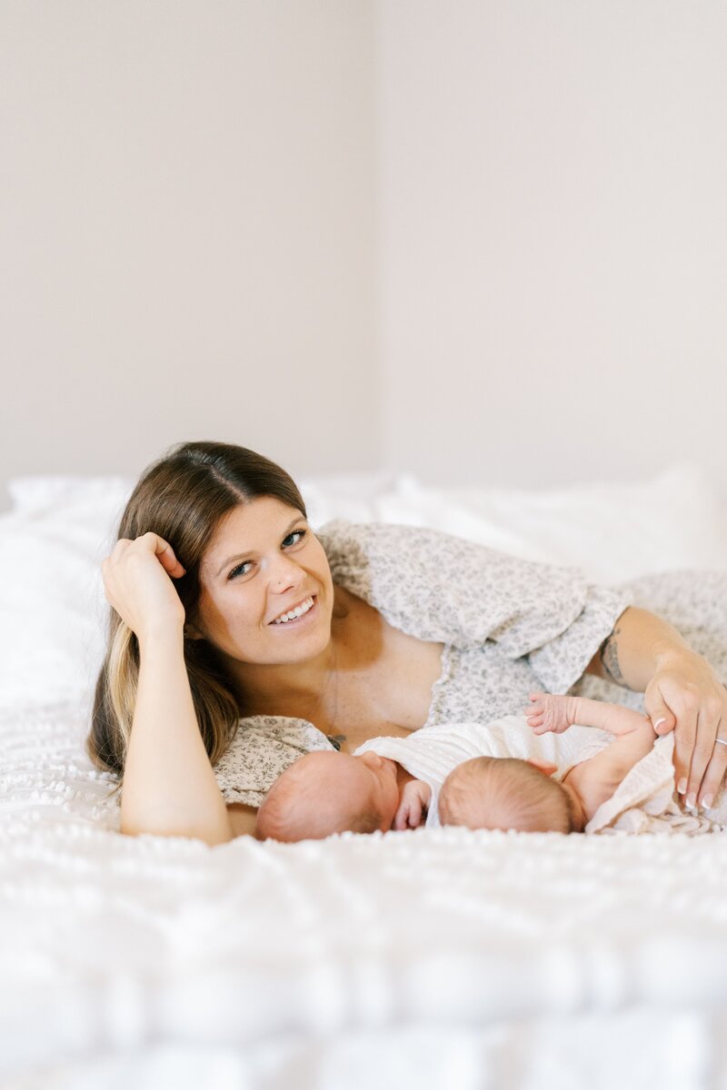 A sweet moment of a mom holding her baby's hand during a Dallas newborn photography session.