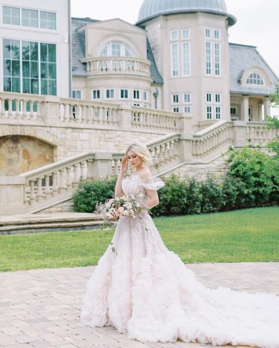 Female model in a wedding dress in front of a ancient stone pillar posing for a photography,