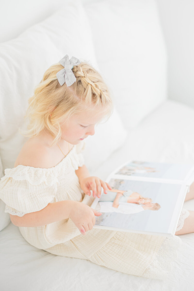 Deborah Jossick, the talented Westport photographer behind Oak & Lore Studio, smiles warmly in a beautifully lit portrait. Her passion for capturing timeless maternity, newborn, and family moments shines through in her elegant and heartfelt photography