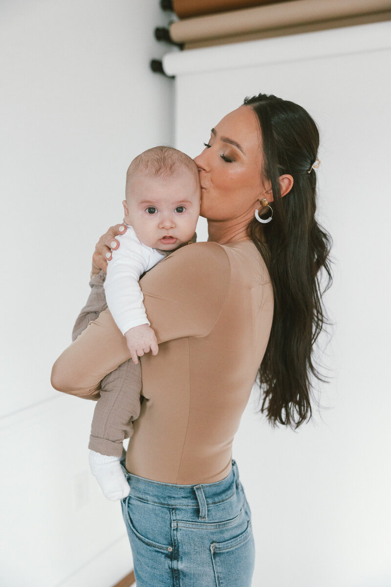 kat holding son in arms
