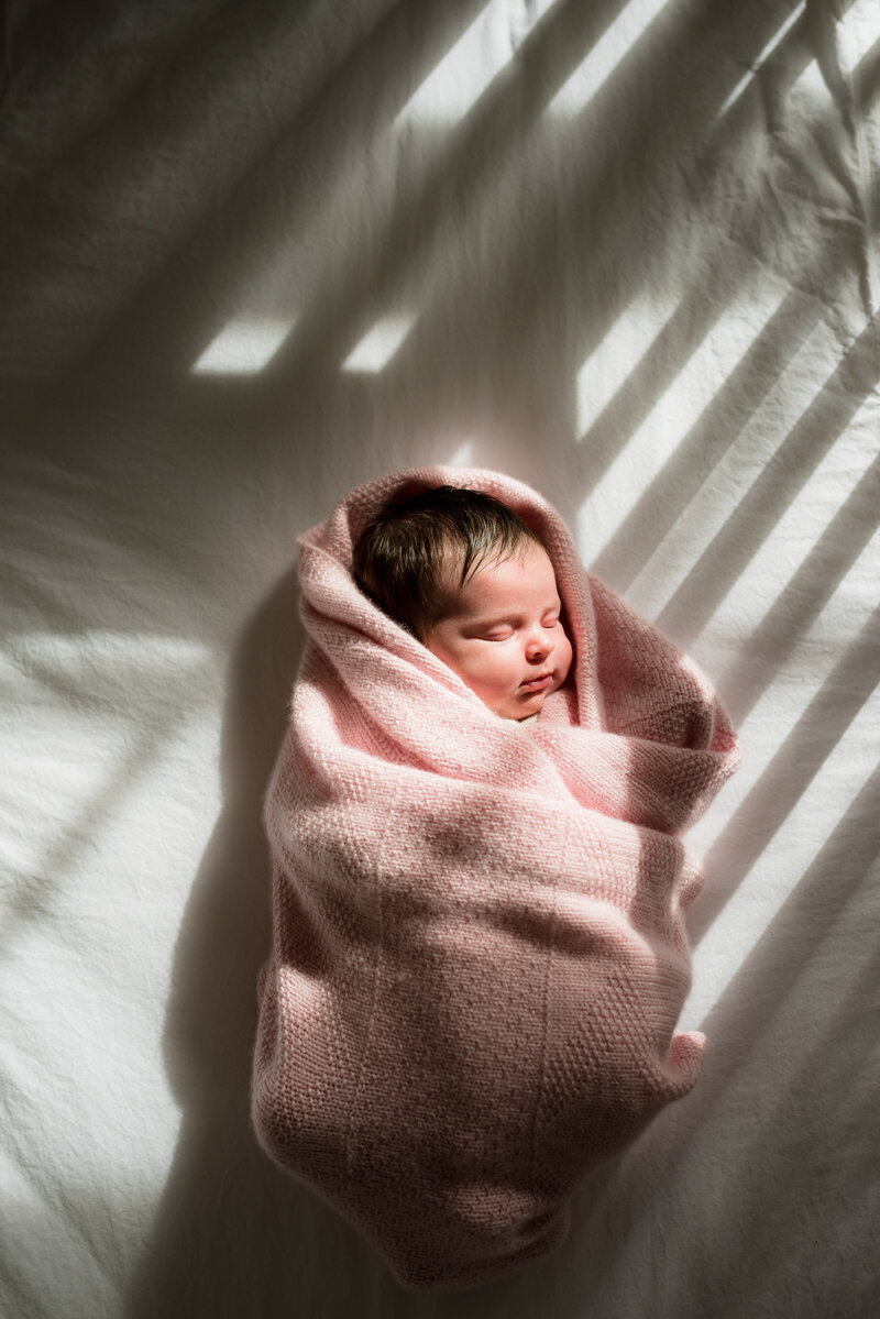 newborn baby girl in her crib