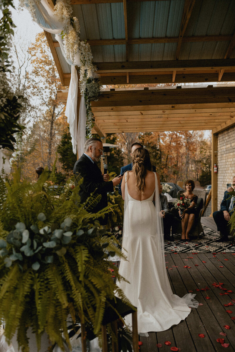 A couple sharing vows in the backyard for their intimate micro wedding