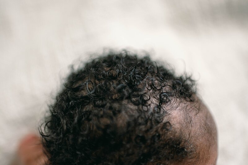 Black baby with curls top of head photo at a Houston Newborn Photography session