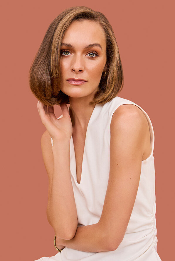Woman with a sleek bob haircut and soft brunette highlights, styled in a luxury Sydney salon.