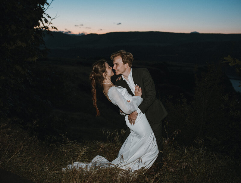 Bride and groom kissing in the dark
