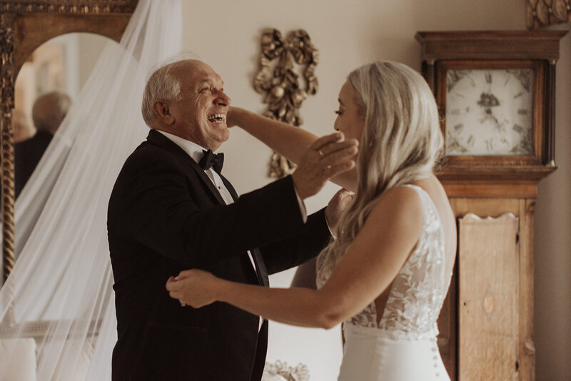 A joyful dance between a bride and an older man in a celebratory wedding moment.