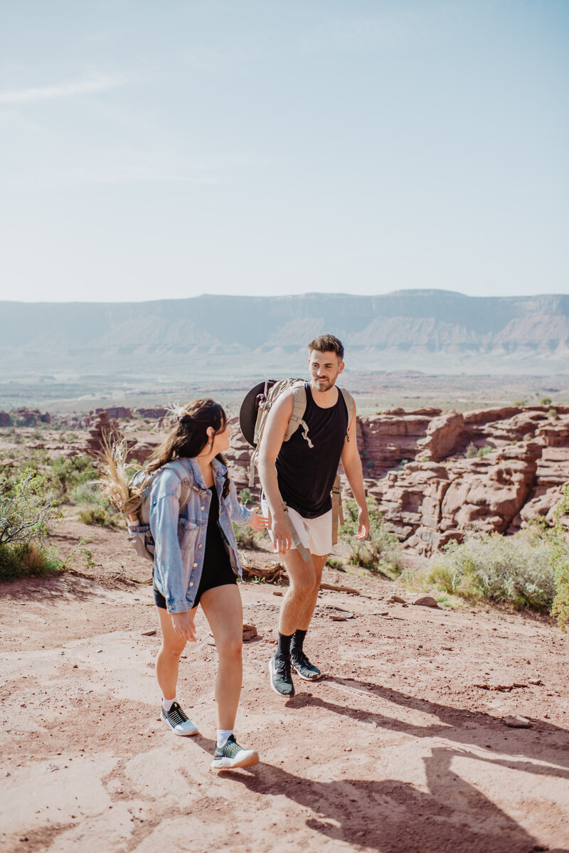 arches national park wedding with man and woman hiking