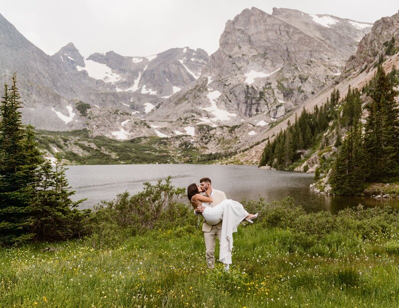Couple sharing a romantic moment during their Lake Isabelle Colorado elopement, captured by a professional elopement photographer and videographer Alpine Vows.