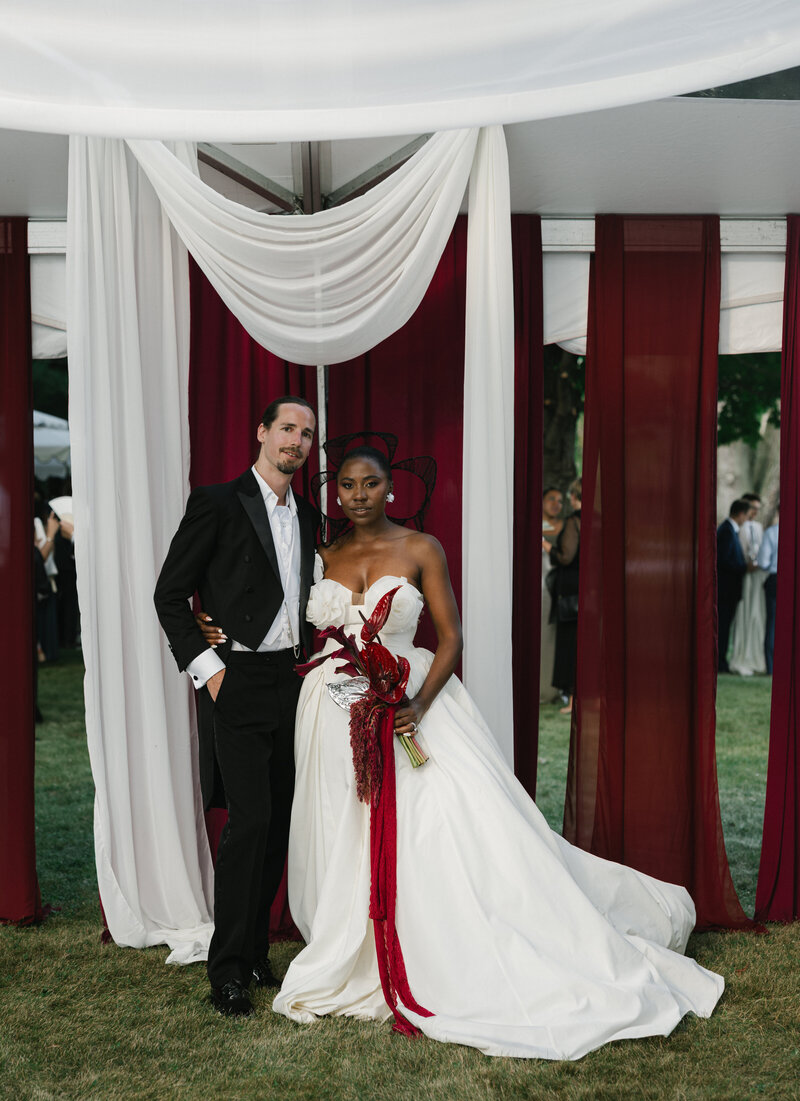 bride and groom posed at tented wedding reception in Milwaukee