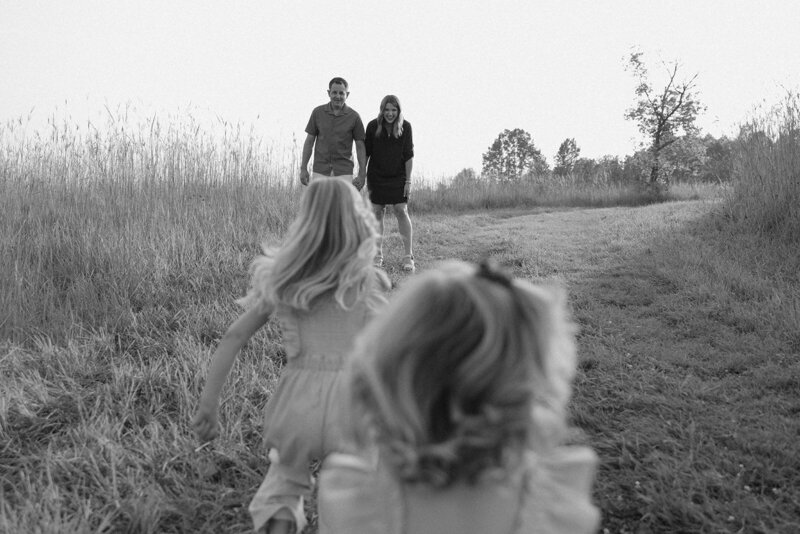 Daughters run towards their parents waiting with open arms