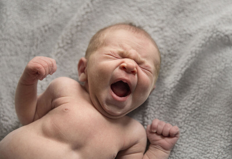 Adorable baby boy yawning during in home lifestyle photo session