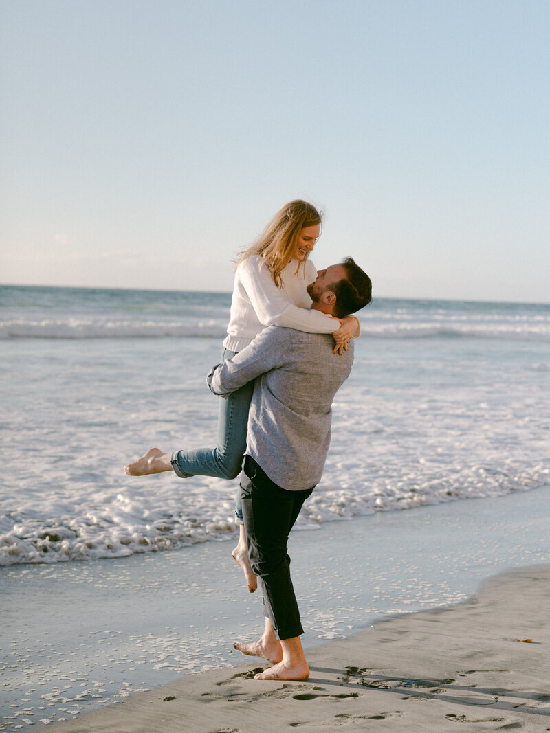 A serene engagement moment at The Lodge at Torrey Pines captured by Michael Asmussen Photography. Amid whispering pines and timeless California architecture, the couple celebrates with rosé and effortless laughter—an image of warmth, elegance, and genuine connection.