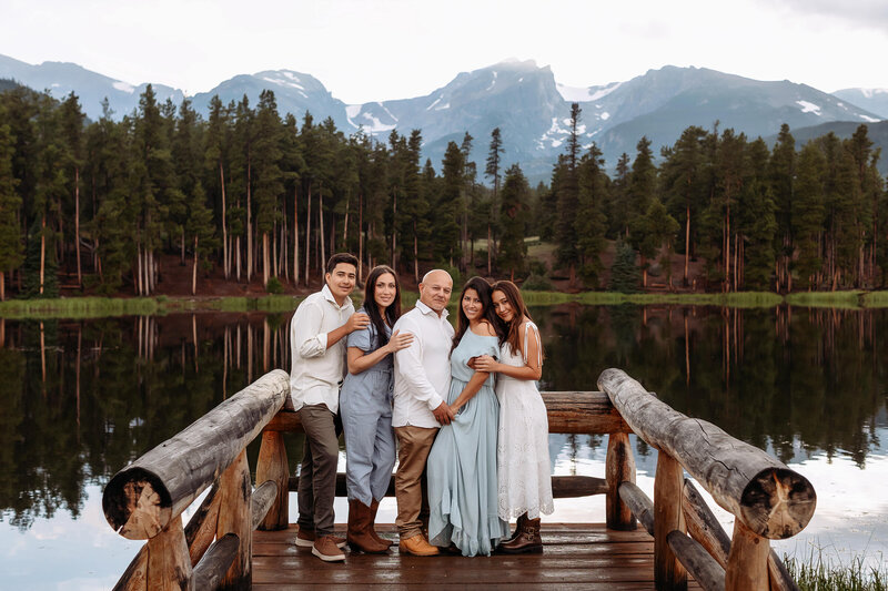 family visiting colorado and enjoying photos in estes park colorado on a stormy summer evening