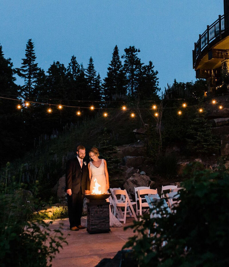 A bride and groom enjoy an outdoor firepit in the evening after their eastern Washington elopement at Swiftwater Cellars