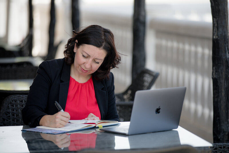Show thumbnail preview	 A woman in a dark blazer stands with her arms crossed in front of a whiteboard with writing on it, exuding an air of post-secondary education expertise. A bookshelf with various items is visible in the background, hinting at her dedication to coaching and guiding others.
