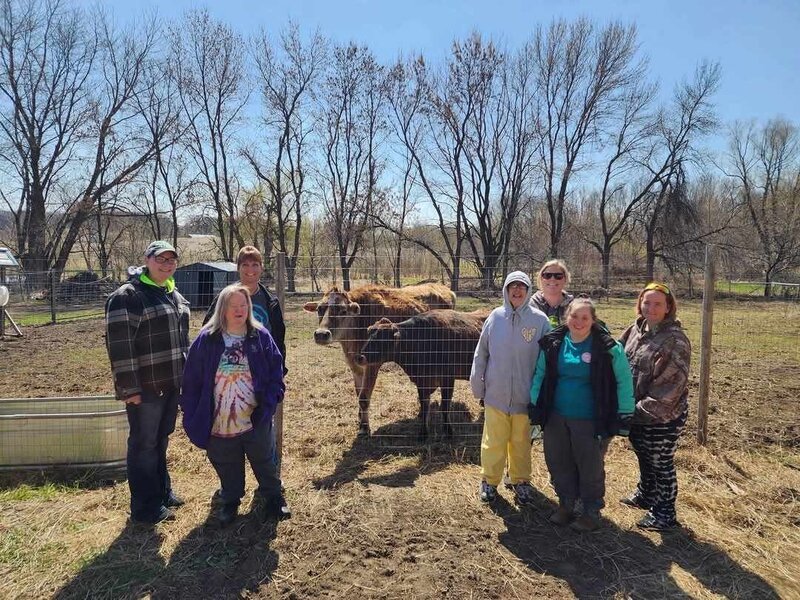 Woman cares for chicken at Farm sanctuary