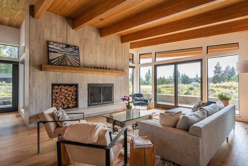 modern-living-concrete-fireplace-wood-beams-glass-sliders