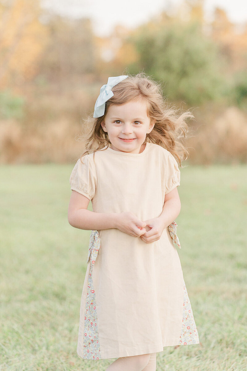 big sister smiling taken by a Sterling, VA fall minis photographer