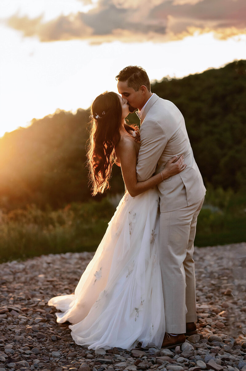 Bride looks up with a nice smile at her groom, as they walk down an aspen tree lined boardwalk in their Aspen, Colorado wedding,