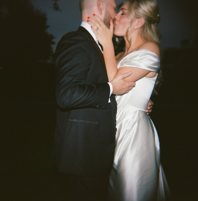 bride and groom walking on porch with plants
