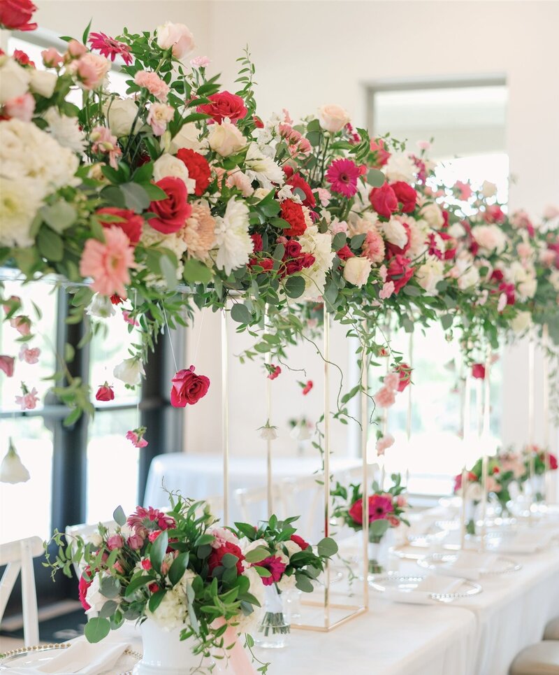 Wedding tall centerpiece with hot pink gerbera daisies by Kendra’s Events in McKinney.