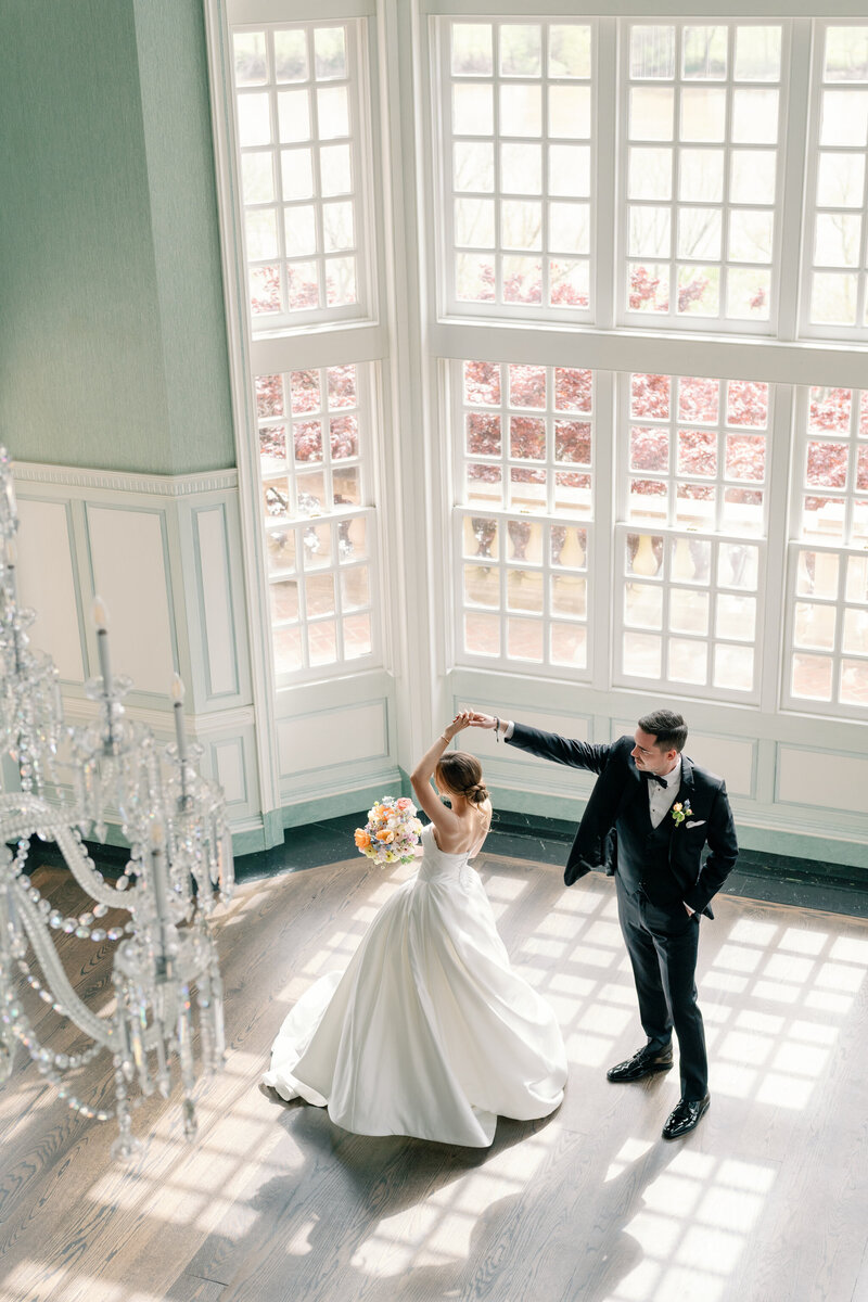 Estate at River Run Wedding in Maidens, VA | Wedding Photographer in Richmond | overhead picture of groom twirling his bride in the ballroom of the Estate at River Run