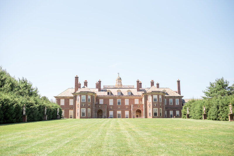 A full view of the breathtaking Castle Hill mansion at The Crane Estate in Ipswich, MA, surrounded by manicured lawns and classic architecture — a perfect setting for a luxurious outdoor wedding.