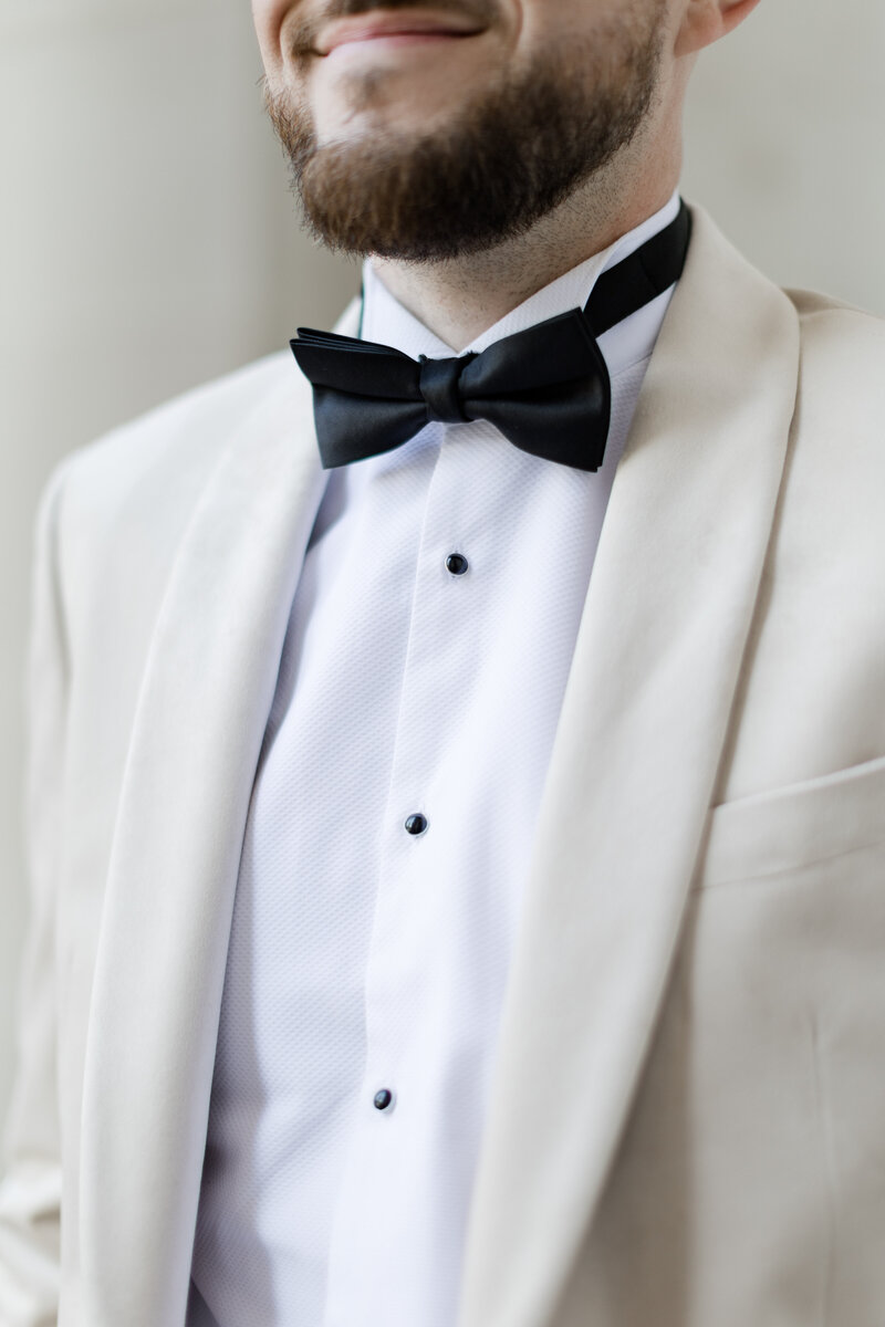groom portrait at the old marylebone town hall wearing a tux with ivory jacket, photographed by adorlee weddings