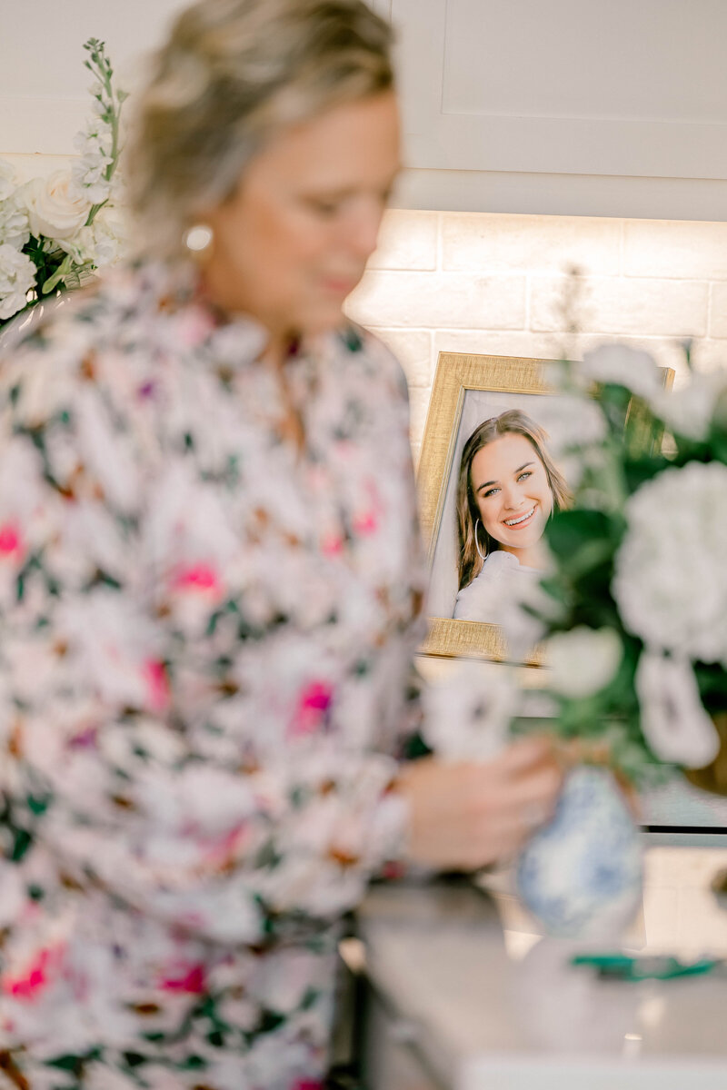 Brunette girl in picture frame behind woman