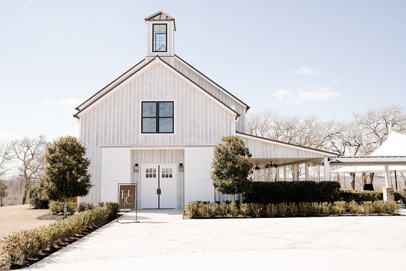 Swank Soiree Dallas Wedding Planner Haile and Christian - Front of white barn venue